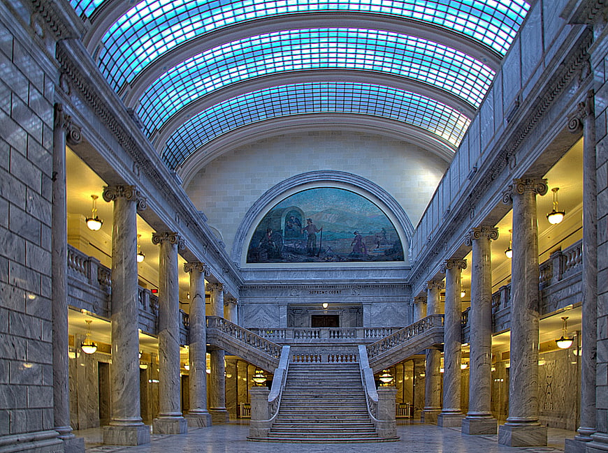 Grand marble interior of a historic courthouse with stained glass ceiling
