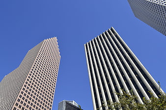 Low angle view of modern skyscrapers against a clear blue sky
