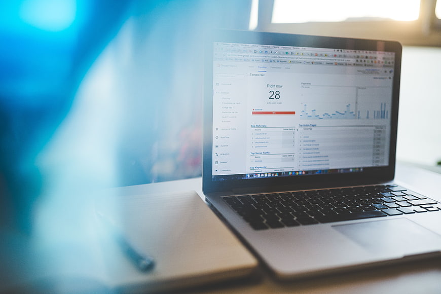 Laptop displaying analytics dashboard on desk