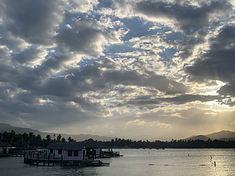 Dramatic Cloudy Sky Over Tropical Water Village at Sunset