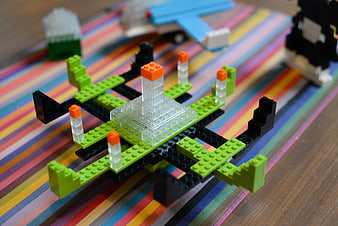 Colorful Lego UFO Toy on Striped Fabric Background