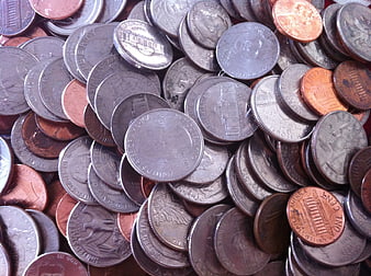 Pile of mixed US coins including pennies, nickels, dimes, and quarters