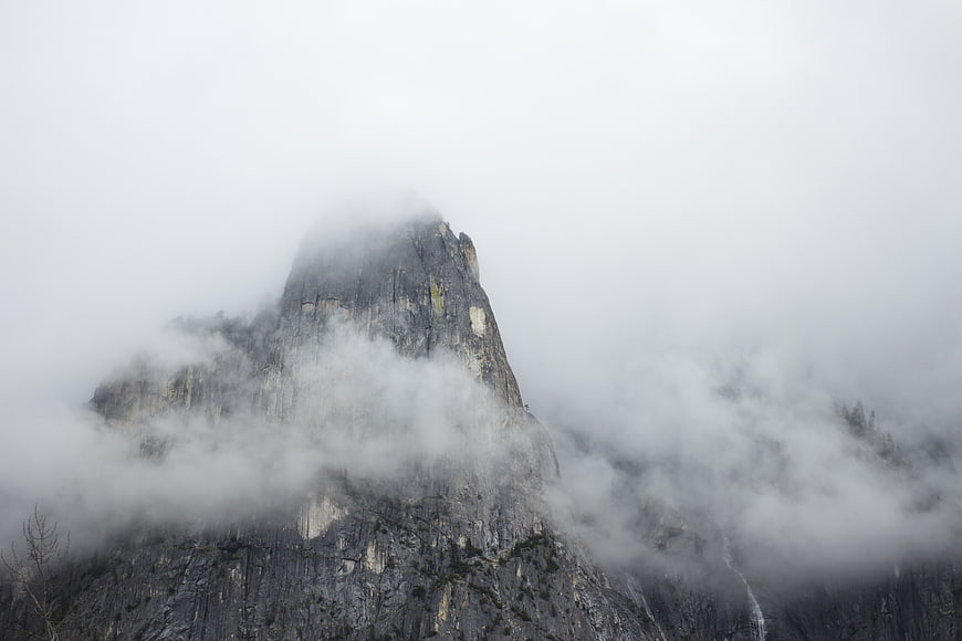 Misty Mountain Peak Emerging Through Thick Fog