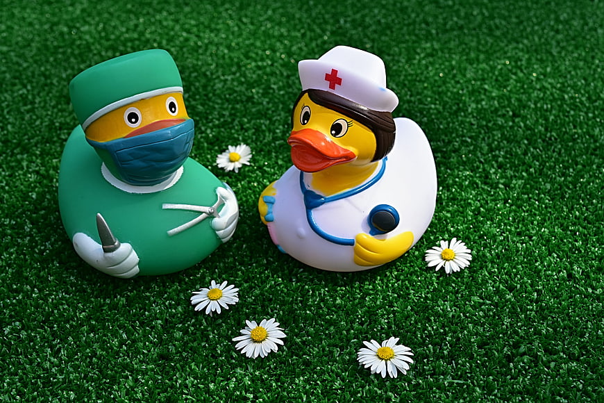 Cute Rubber Duck Doctor and Nurse Toys on Green Grass