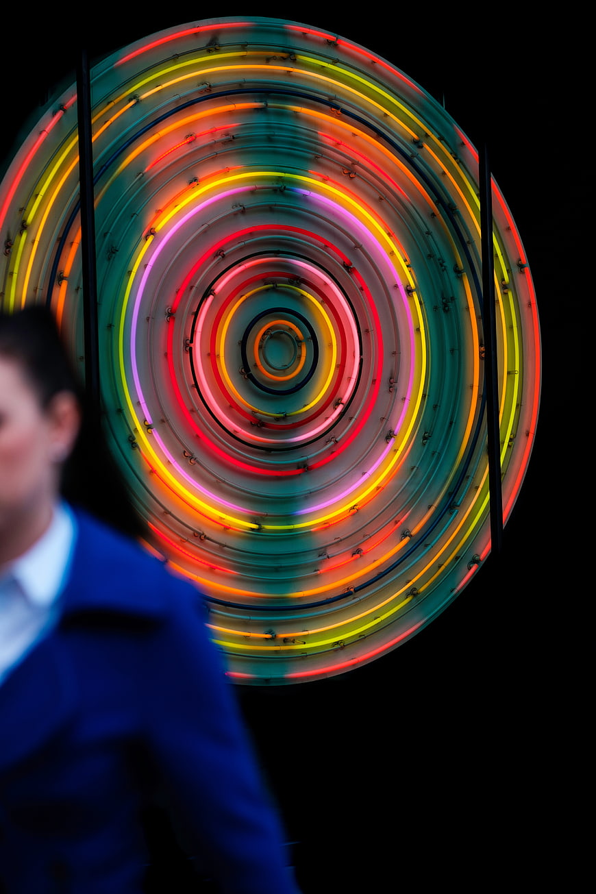 Colorful Neon Spiral Light Installation with Blurred Figure