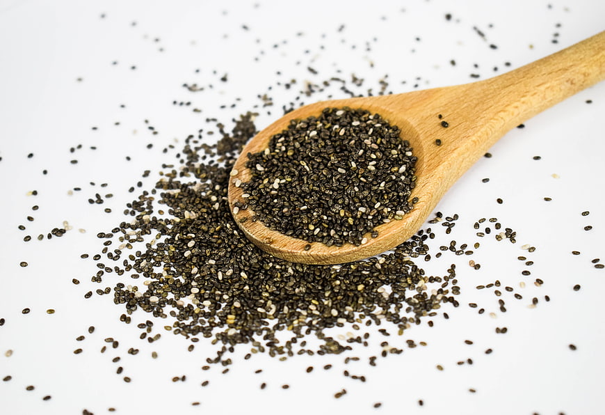 Wooden Spoon with Chia Seeds on White Background