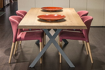 Modern Dining Table With Pink Upholstered Chairs And Red Bowls