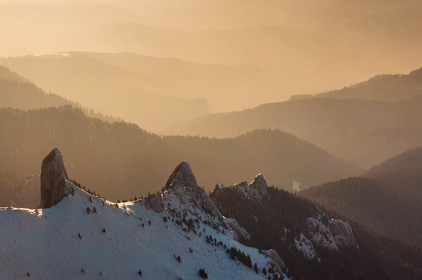 Snowy Mountain Peaks in Golden Hazy Light