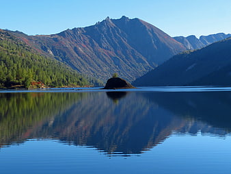 Serene Mountain Lake with Perfect Reflection and Small Island