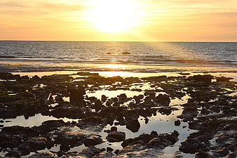 Golden Sunset Over Rocky Tide Pools and Ocean Waves