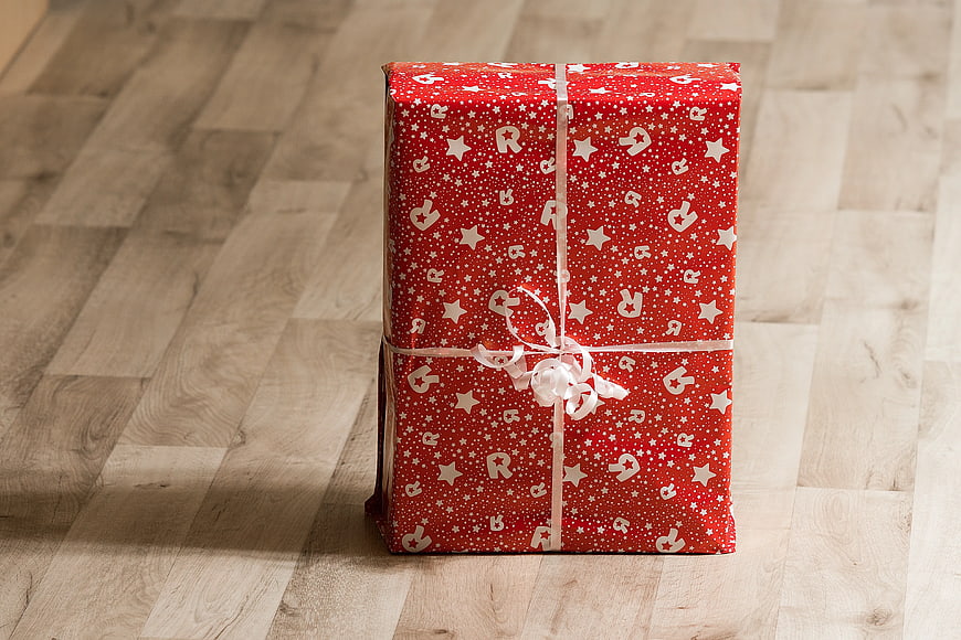 Red Christmas Gift Box on Wooden Floor