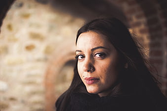 Close-up portrait of woman with nose ring looking at camera