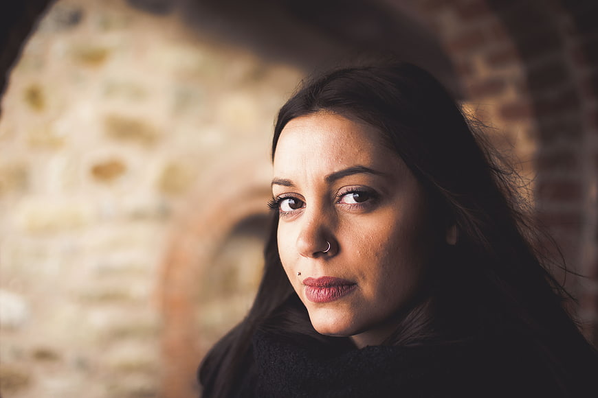 Close-up portrait of woman with nose ring looking at camera