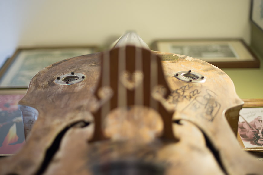 Close-up of vintage wooden double bass with handwritten signatures