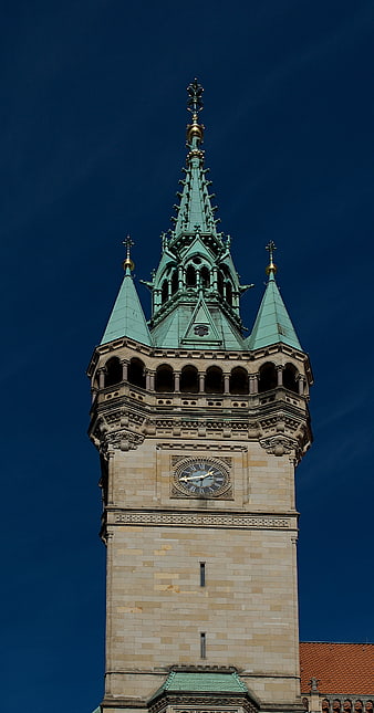 Gothic Clock Tower Spire Against Deep Blue Sky