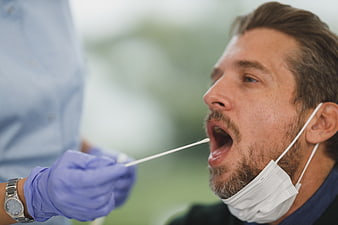 Close-up of man receiving nasal swab test for virus