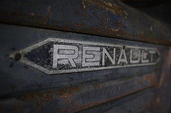 Close-up of rusty vintage Renault emblem on old car