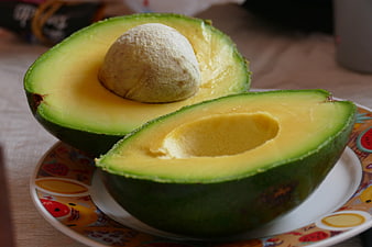 Fresh Halved Avocado With Seed On Decorative Plate