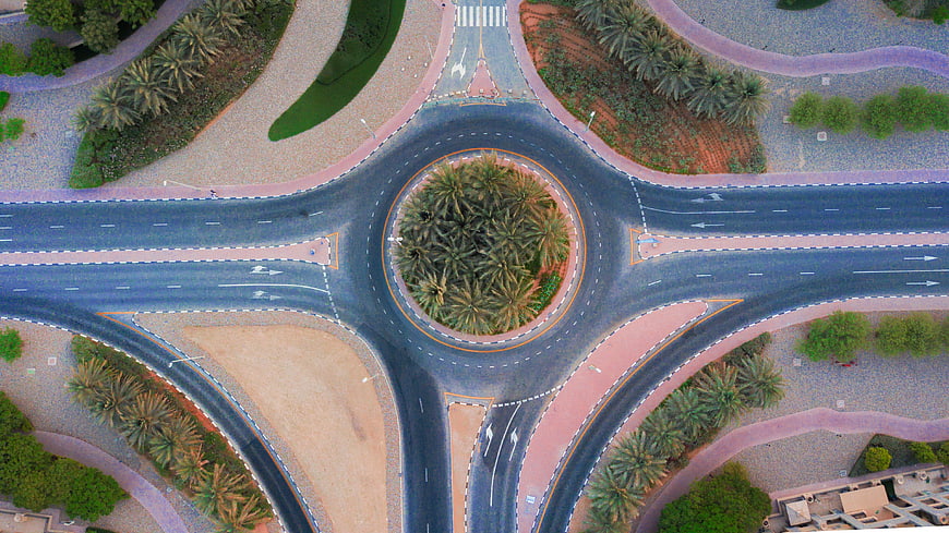 Aerial View of Roundabout with Palm Trees in Desert Landscape