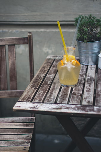 Refreshing lemonade pitcher on rustic wooden outdoor table