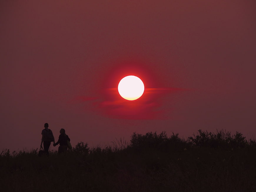 Silhouette of Couple Walking Hand in Hand at Sunset