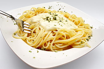 Creamy Spaghetti Pasta Dish With Herbs On White Plate