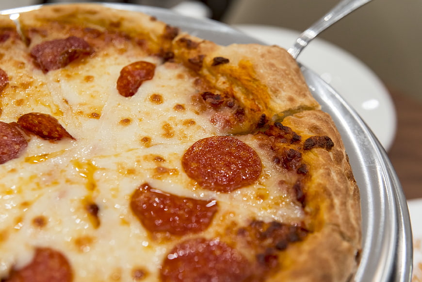 Close-up of freshly baked pepperoni pizza on metal tray