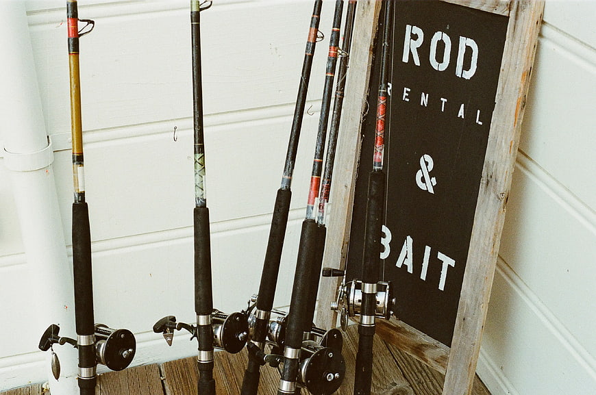 Fishing Rods Leaning Against Wall with Rental Sign