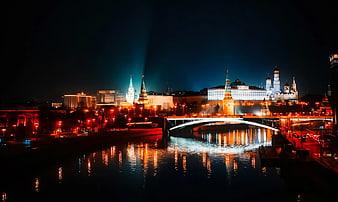 Moscow Kremlin Night View with Illuminated Towers and River Reflections