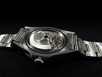 Silver mechanical watch back with visible movement