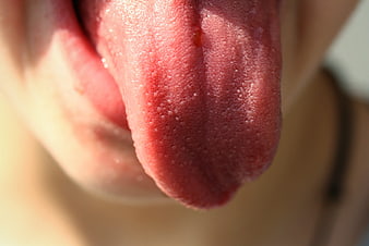 Close-up of human tongue with visible papillae texture