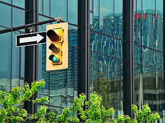 Green Traffic Light Signal Against Modern Glass Building