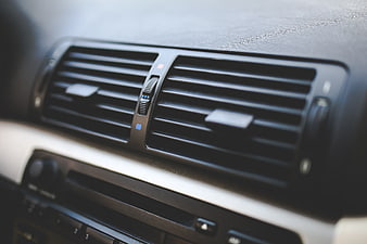 Close-up of car air conditioning vents on dashboard