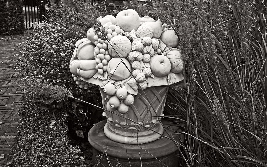 Black and white stone fruit urn garden sculpture