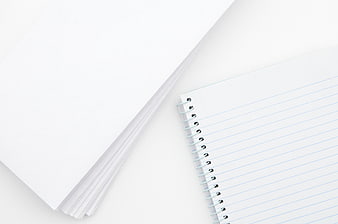 Minimalist White Paper Stack and Spiral Notebook Flat Lay