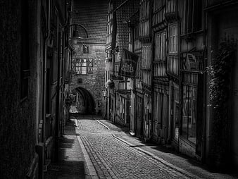 Black and white cobblestone alley in medieval European town