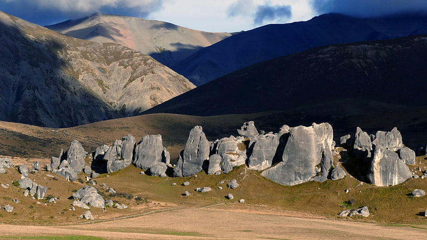 Dramatic mountain landscape with large rock formations and shadows
