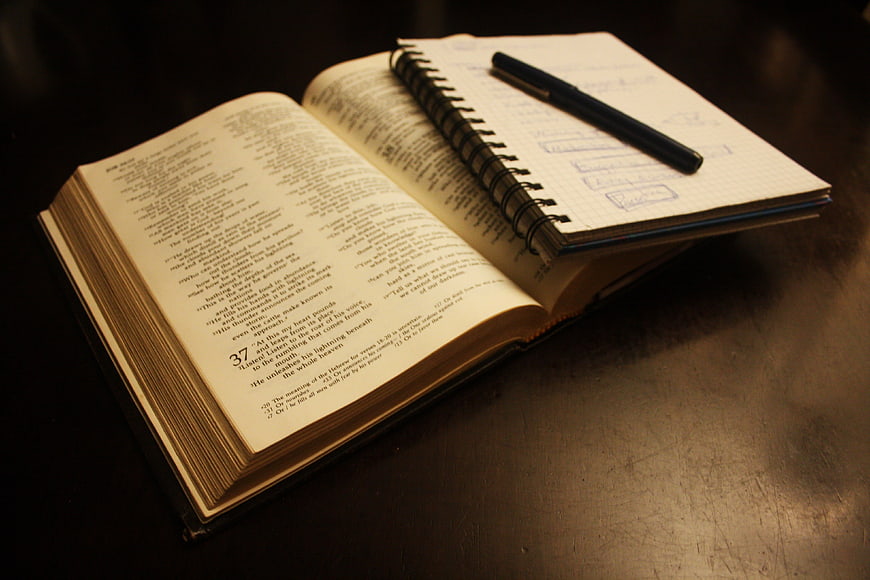 Open Bible with Notebook and Pen for Study