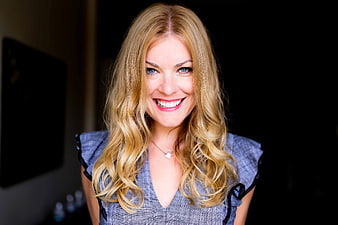 Smiling blonde woman portrait with blue eyes and wavy hair