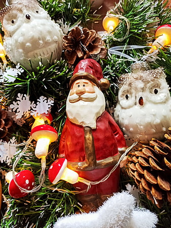 Close-up of Santa Claus and Owl Christmas Tree Ornaments