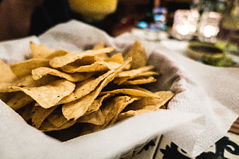 Close-up of tortilla chips in a basket with napkin