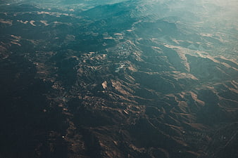 Aerial View of Rugged Mountain Ranges with Atmospheric Haze
