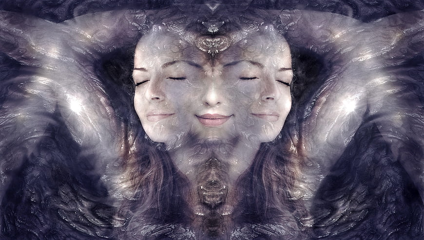 Surreal mirrored portrait of a woman with closed eyes and ethereal wings
