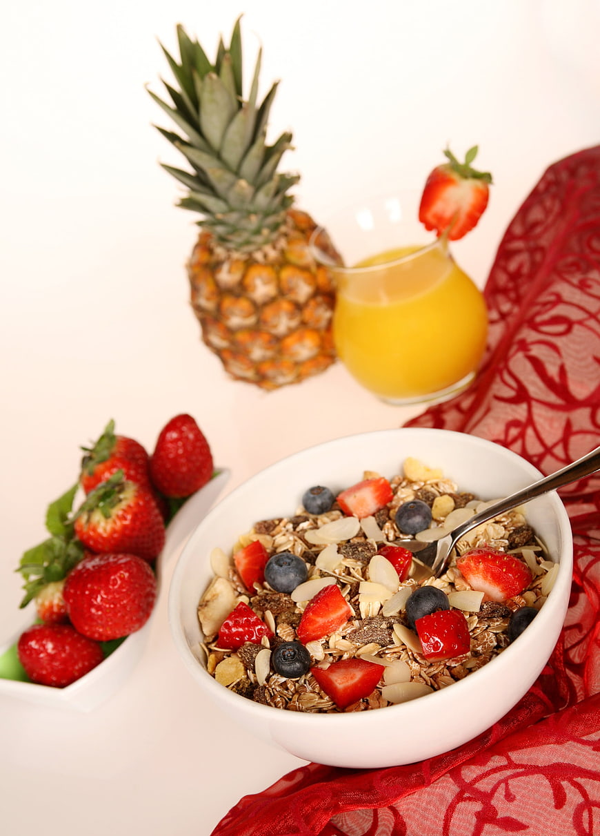 Healthy Breakfast Bowl with Muesli, Berries, and Orange Juice