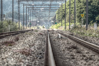 Abandoned Railway Tracks With Catenary Poles And Gravel Ballast