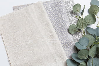 Textured Fabric Swatches with Eucalyptus Leaves on White Background