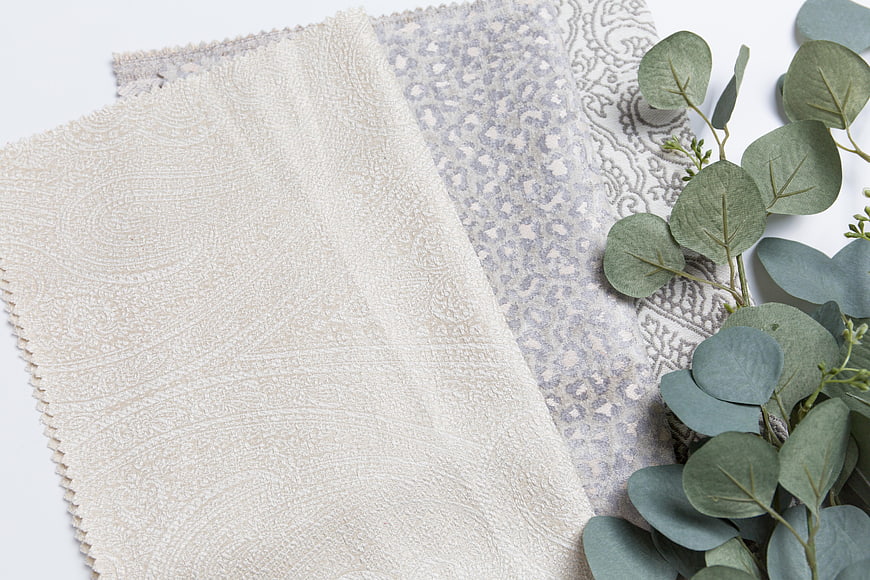 Textured Fabric Swatches with Eucalyptus Leaves on White Background