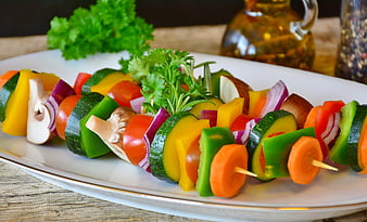 Colorful Vegetable Skewers on White Plate with Herbs