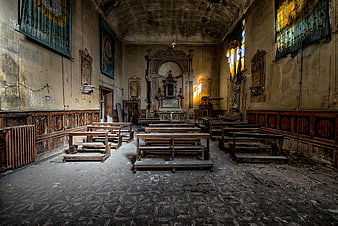 Abandoned Church Interior with Dilapidated Wooden Pews and Altar