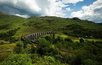 Glenfinnan Viaduct in Scottish Highlands with Green Hills